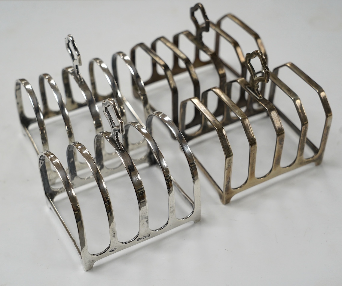 Two pairs of silver five bar toast racks, Birmingham, 1931 and Birmingham, 1932, 75mm, 10.7oz. Condition - fair